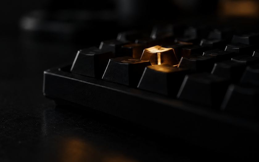 Black keyboard with one key lit in yellow