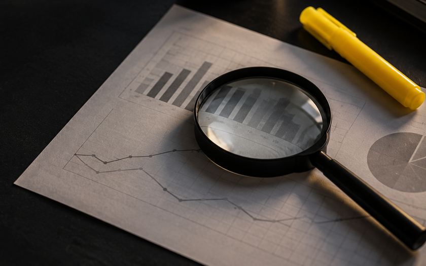 Magnifying glass over a printed performance chart