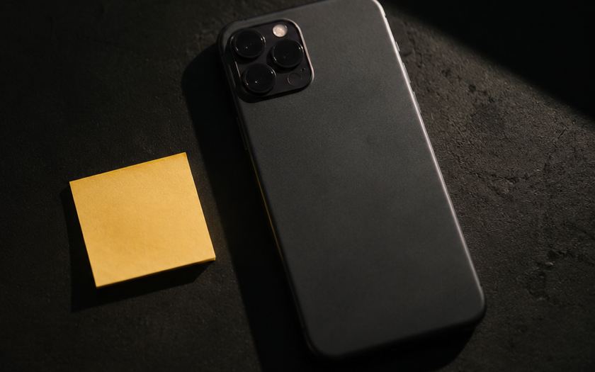 Phone face down beside a yellow sticky note